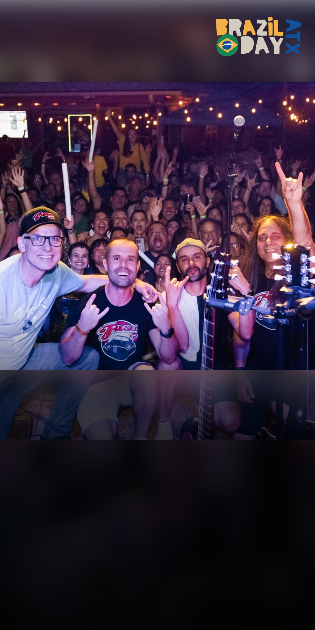 The band Fusca XR3 on stage with the crowd celebrating behind them at Brazil Day ATX