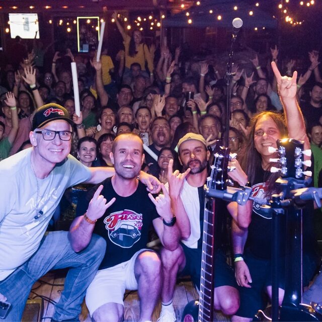 The band Fusca XR3 on stage with the crowd celebrating behind them at Brazil Day ATX