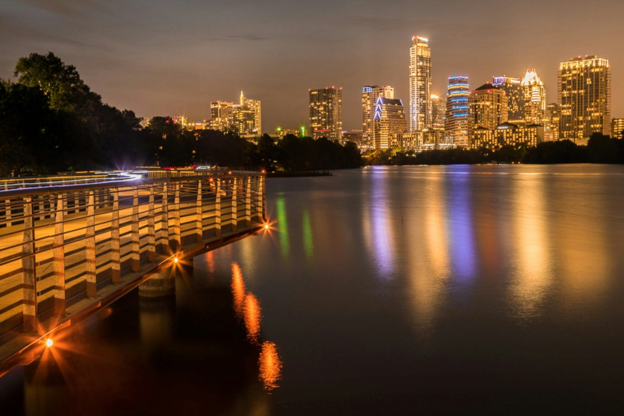 Aerial night view of the Austin, Texas skyline glowing with city lights