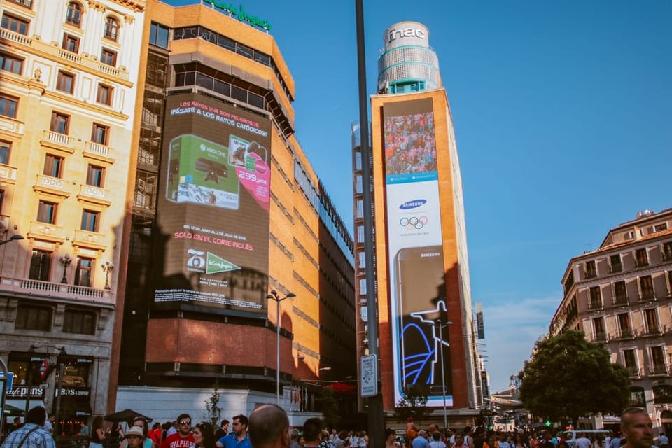 Digital billboards over a busy city square