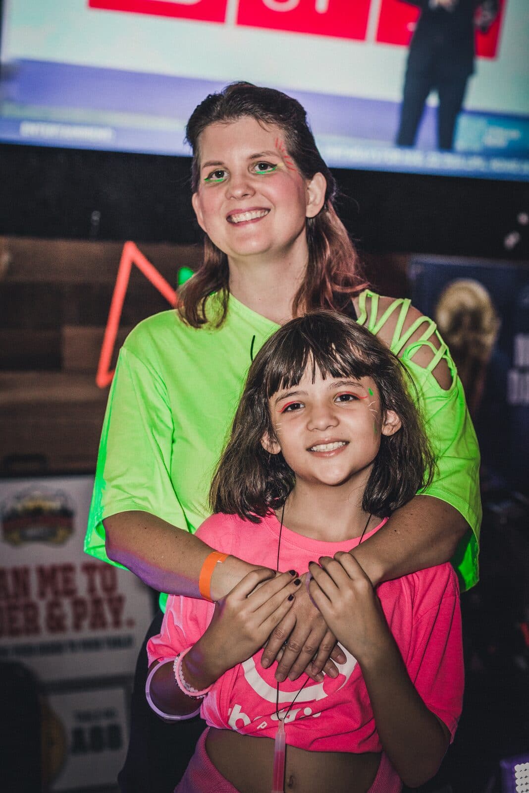 A mother and daughter smiling together at the party