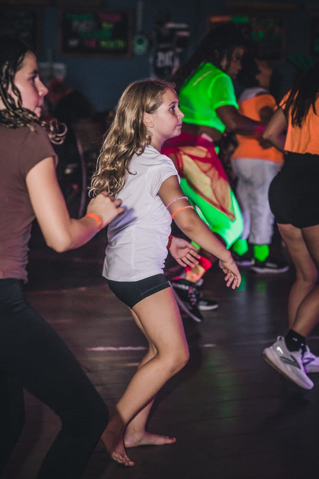 Dancers in motion under the party lights